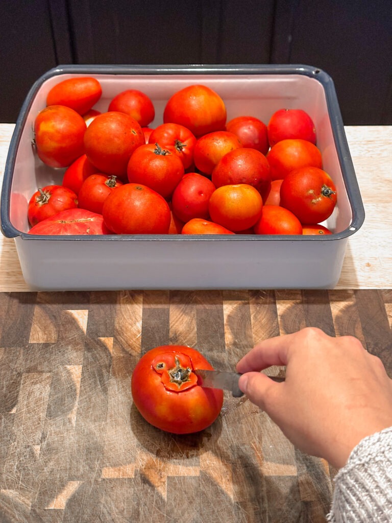 Fresh tomato being cored for the freezer 