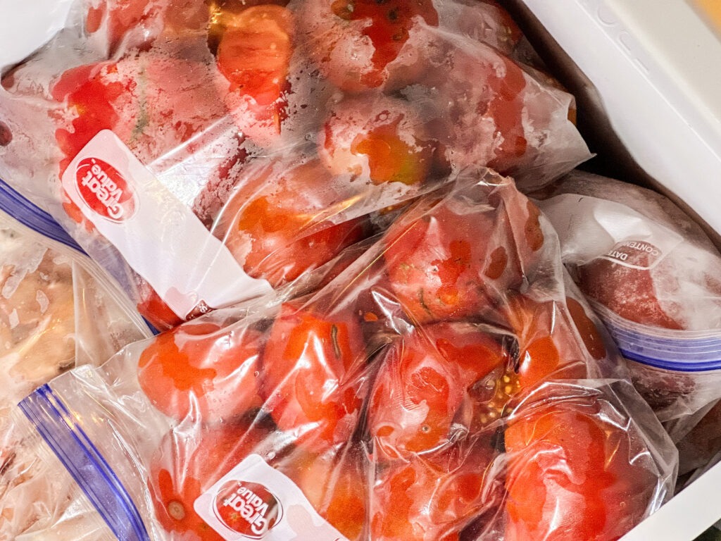 Tomatoes being frozen in freezer bags