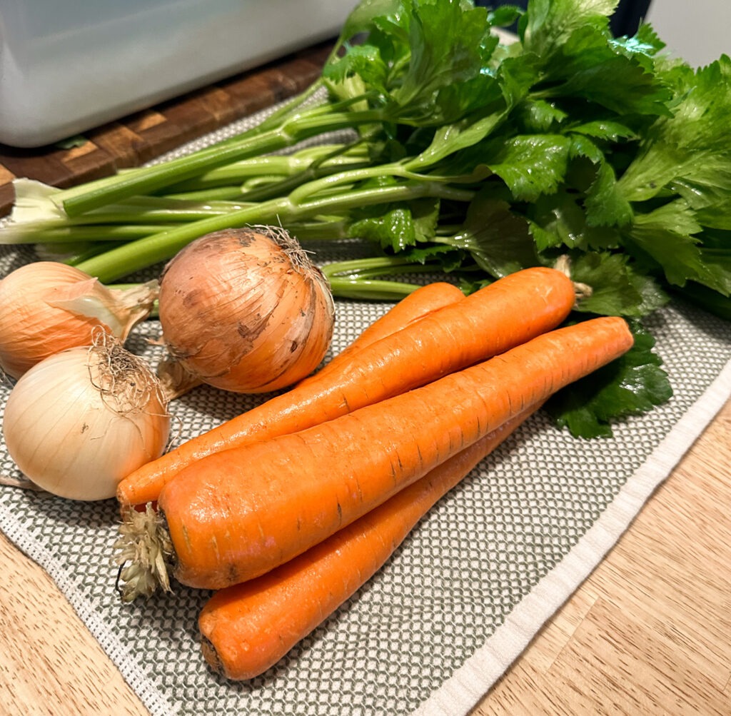fresh carrots, onions, and celery for making soup