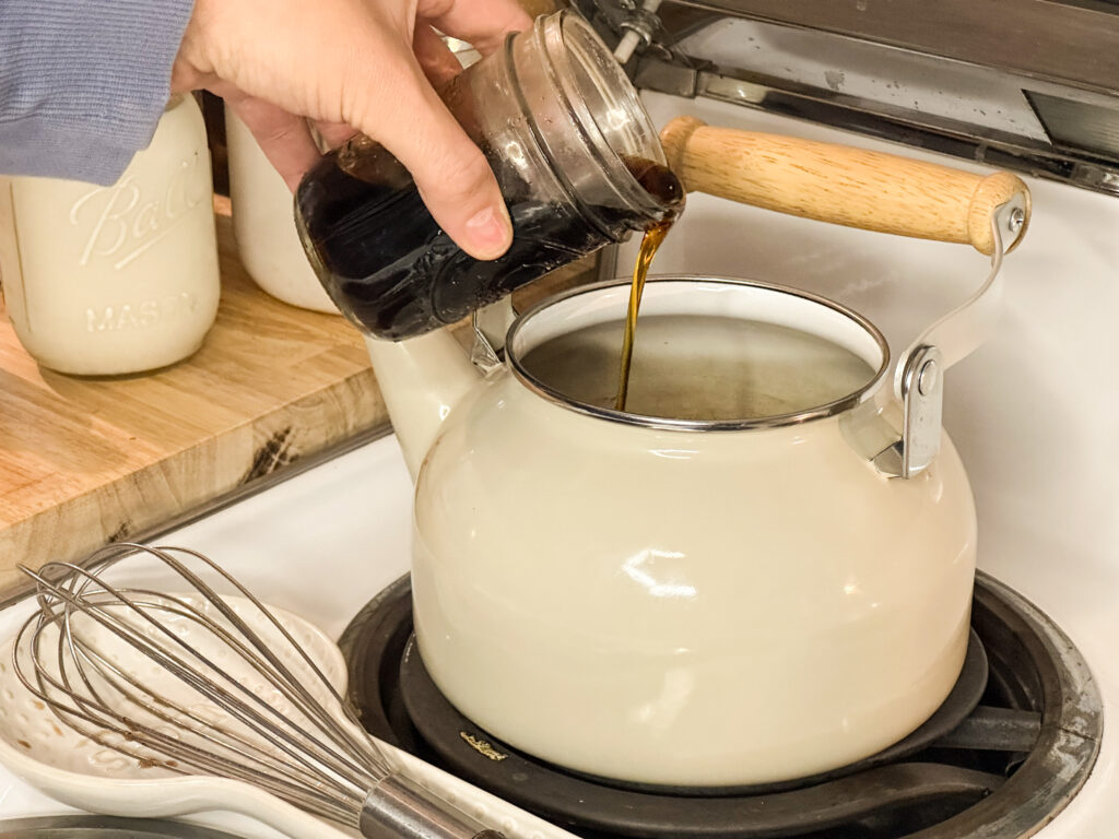 Maple syrup being added to bone broth hot chocolate to naturally sweeten. 